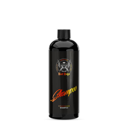 Autošampon v černé lahvi s uzávěrem, oranžový dekor a nápis Shampoo.